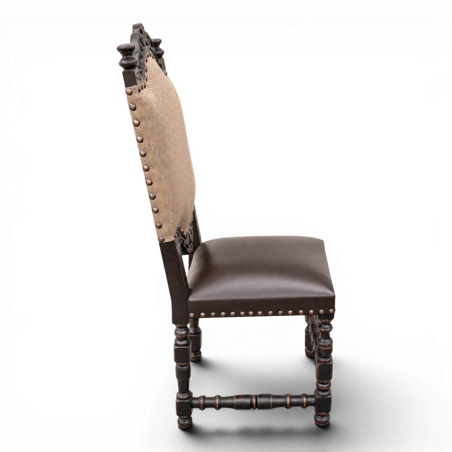 Handmade dining chair with dark carved wood frame, leather seat, and nailhead trim