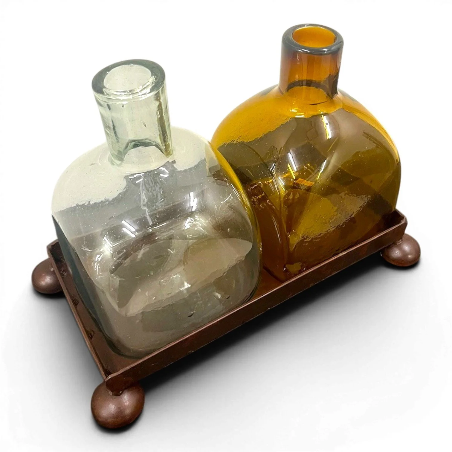 Handmade Mexican serving set featuring two handblown glass bottles and a handcrafted iron tray, perfect for entertaining and rustic décor.