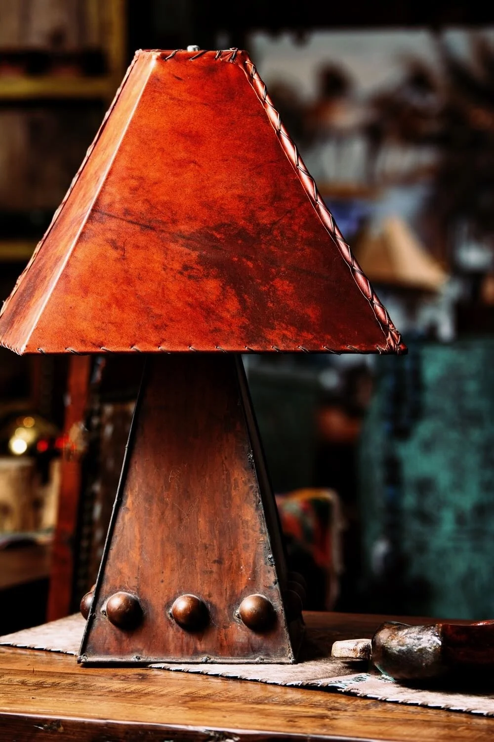 Red rawhide lampshade and iron table lamp from Mexico.