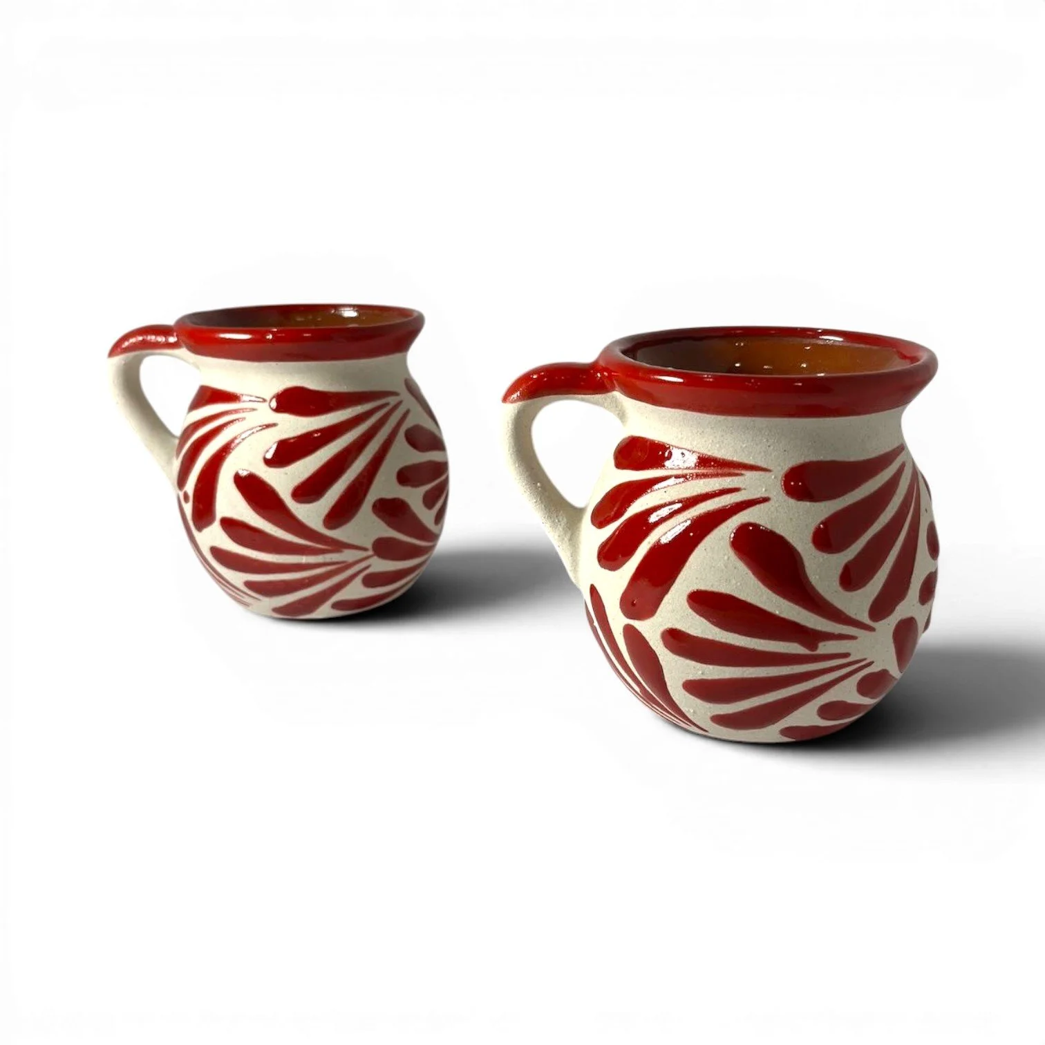 Handmade Mexican red clay mug set with glazed rims and artisan interior and exterior design.