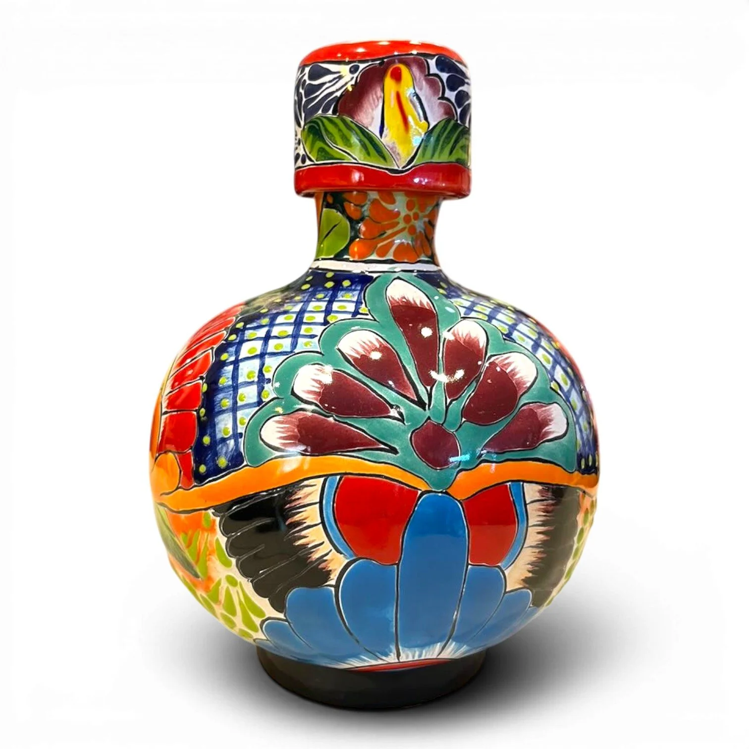 Handmade Mexican Talavera tequila bottle with matching cup featuring vibrant hand-painted ceramic design.