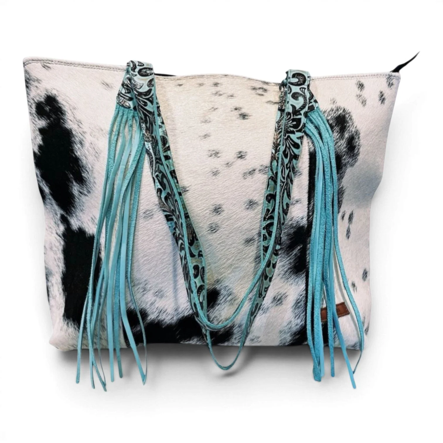 Handmade Brazilian Sheridan cowhide tote bag with black and white hide, black leather back, and turquoise fringe strap
