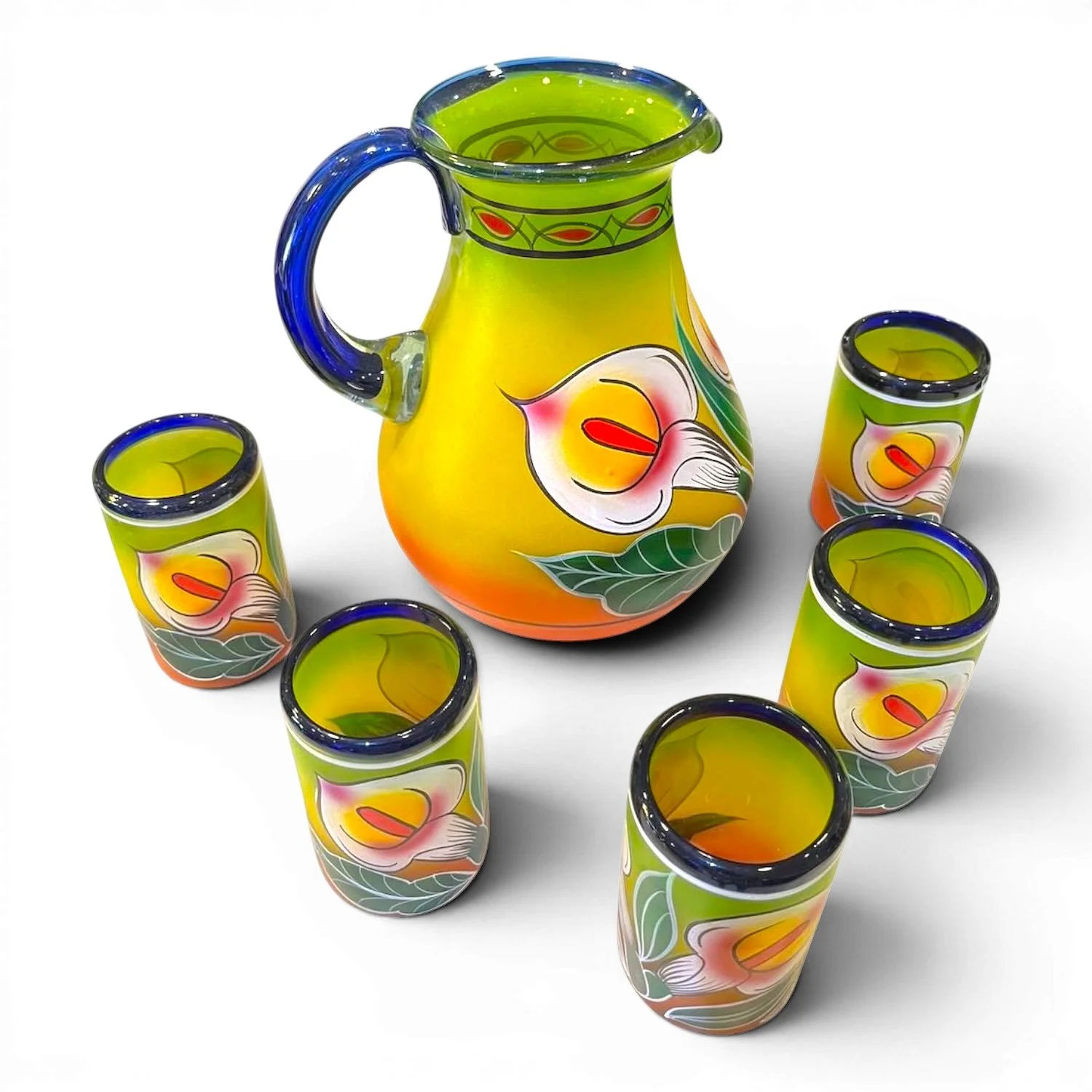 Handblown painted calla lily glass pitcher with five matching tumblers handmade in Mexico featuring blue accents and vibrant floral artwork.