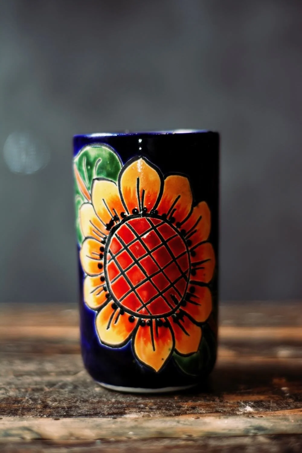 Talavera Sunflower Pitcher & Cup Set. Hand-painted Talavera set featuring a cobalt blue pitcher and matching cups with a vibrant sunflower design.
