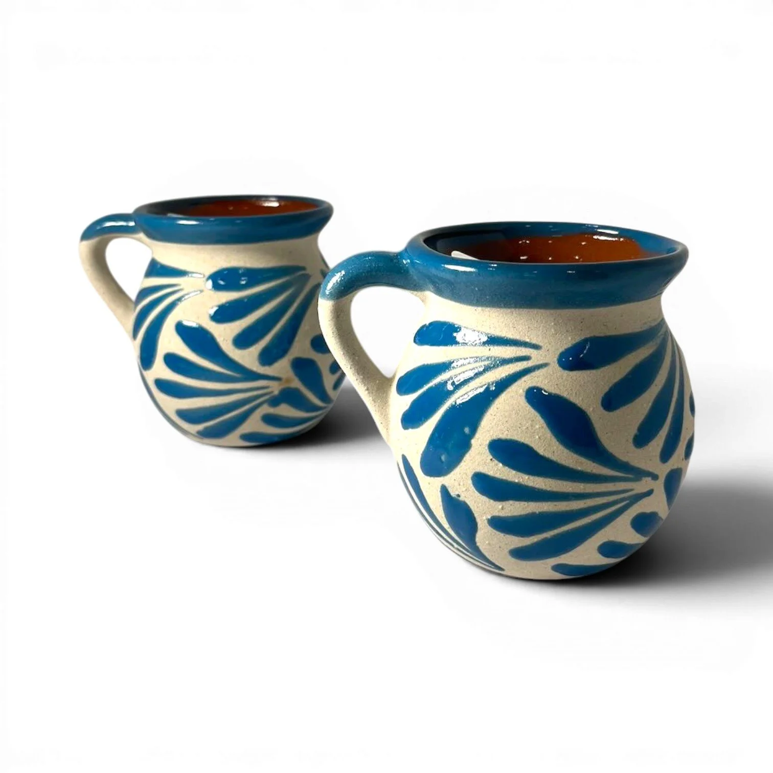 Handmade Mexican light blue clay mug set with glazed rims and artisan interior and exterior design.