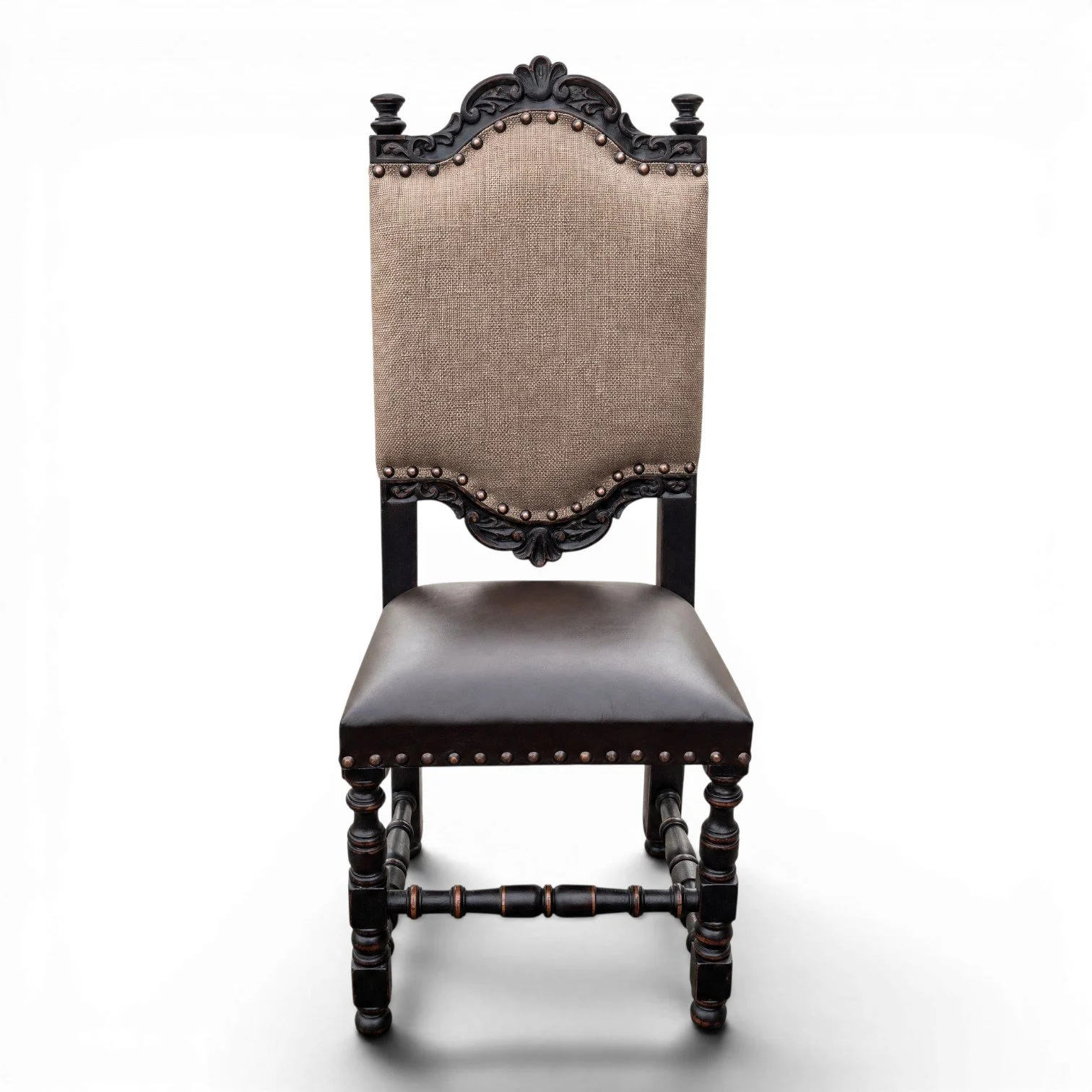 Handmade dining chair with dark carved wood frame, leather seat, and nailhead trim