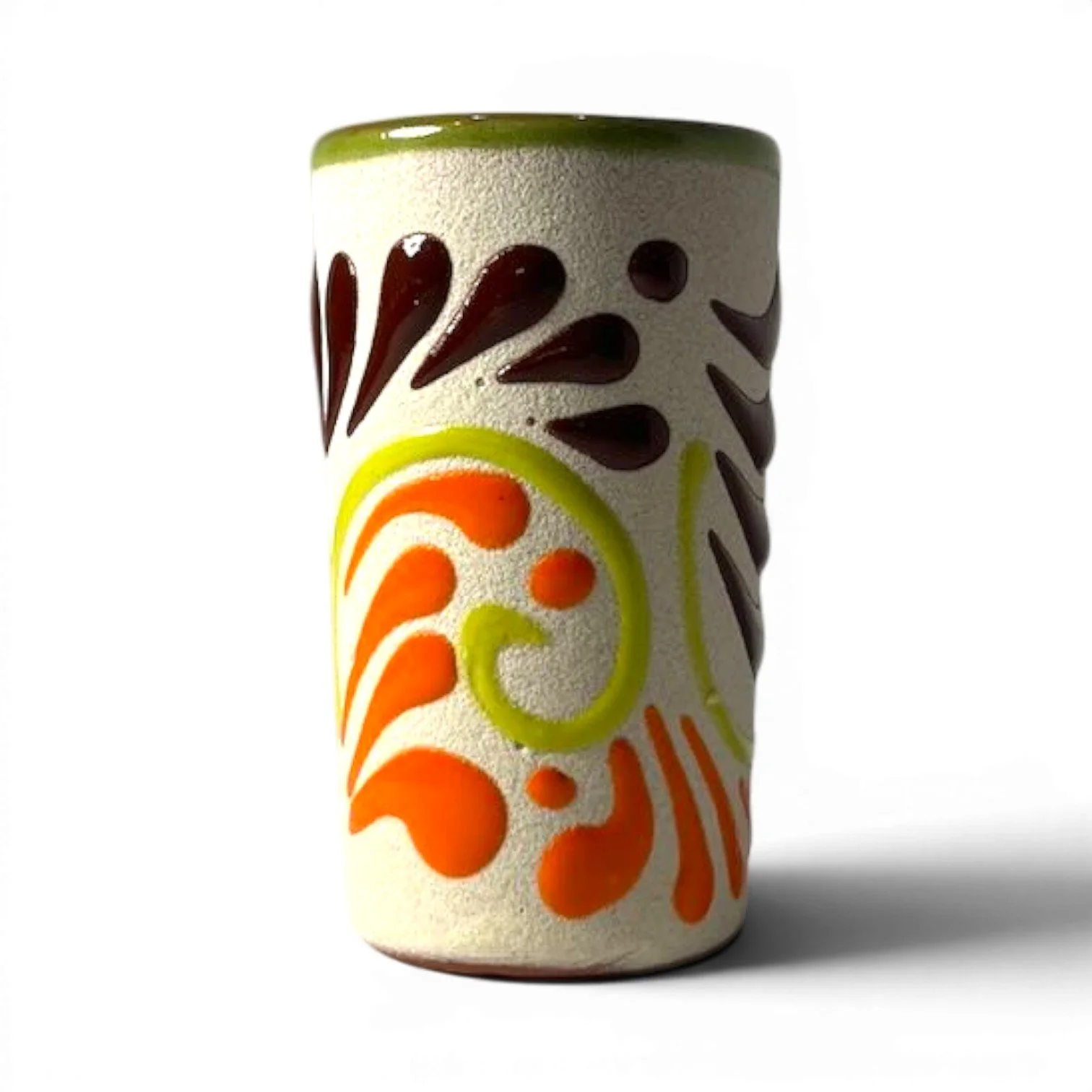 Handmade Mexican stone tequila shot cups with vibrant Talavera design and glazed interior.