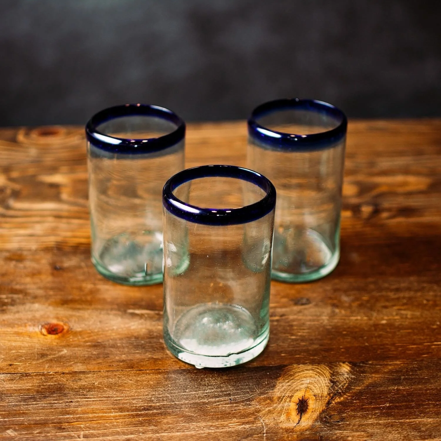 Handmade Mexican Cantina tall glass with traditional cobalt blue rim and handblown artisan craftsmanship.