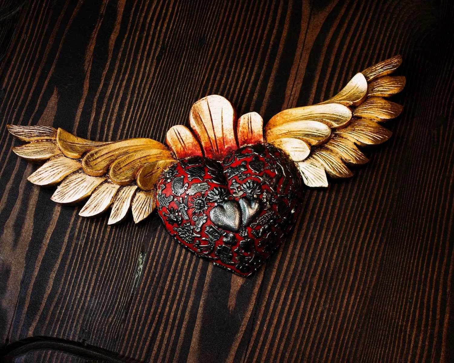 Handmade Mexican golden angel wings wall décor with traditional silver milagros charms.