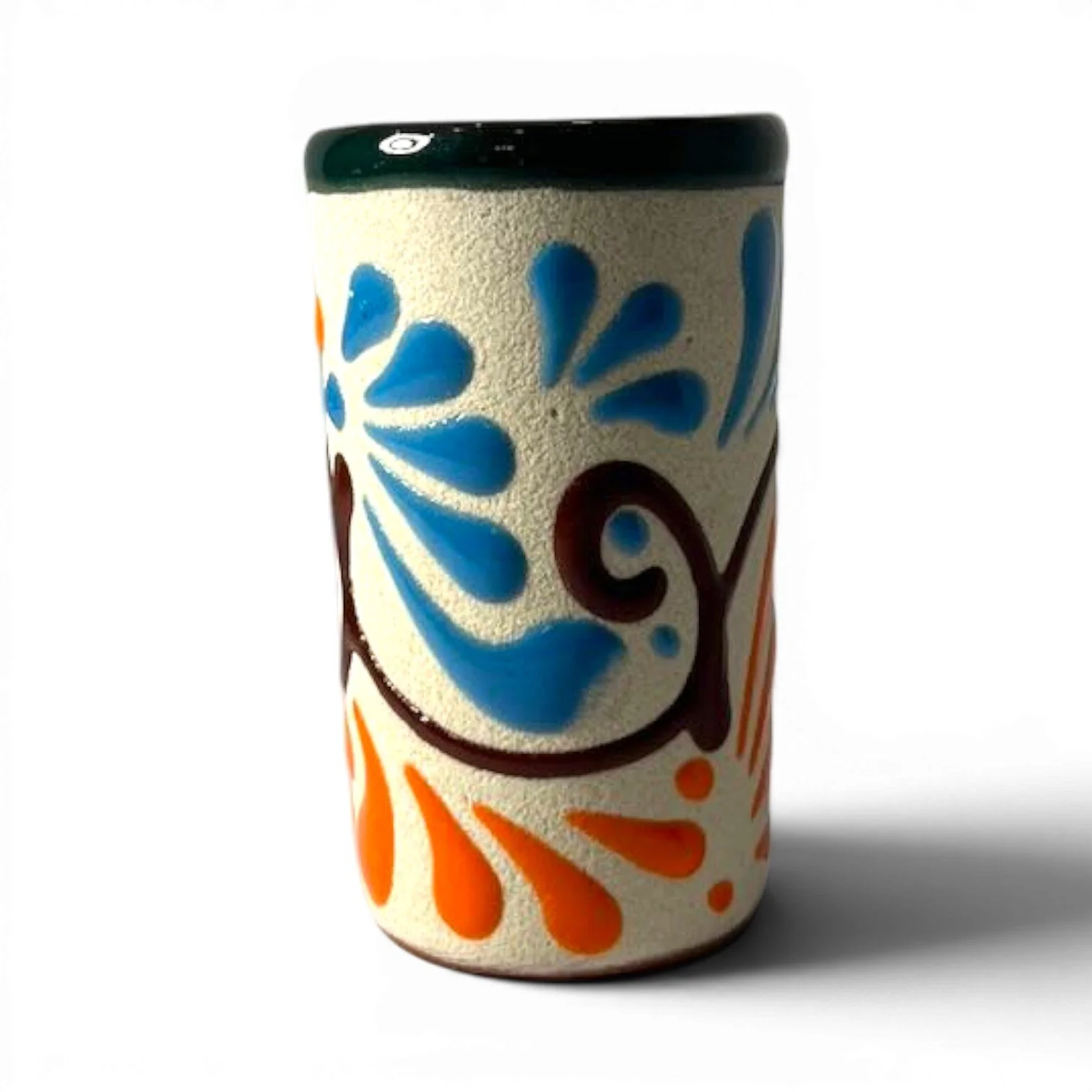Handmade Mexican stone tequila shot cups with vibrant Talavera design and glazed interior.