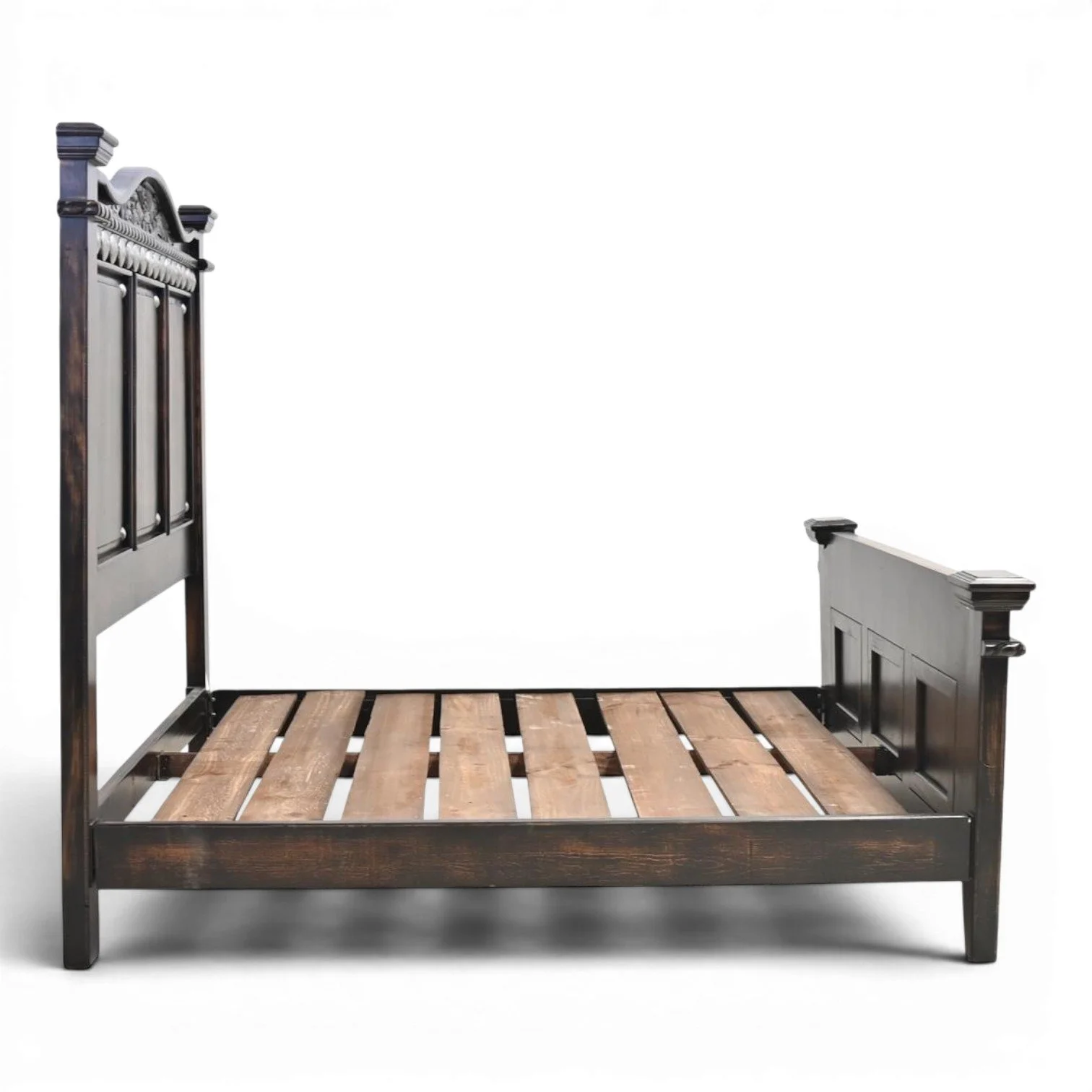 Handmade Arenas Negras bed with distressed black finish, hand-carved details, and silver clavos accents