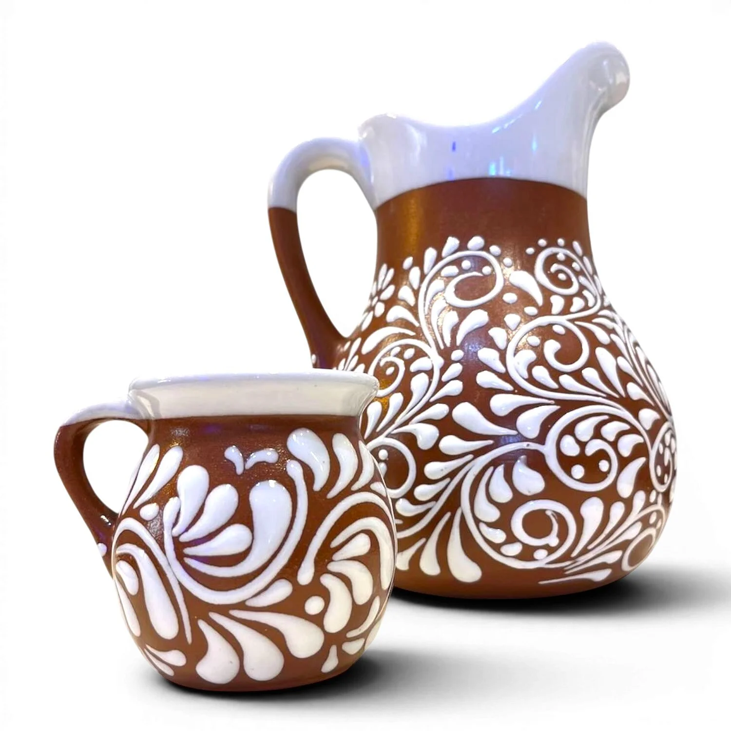Handcrafted Mexican barro pitcher with white Talavera-inspired design and six matching clay cups.