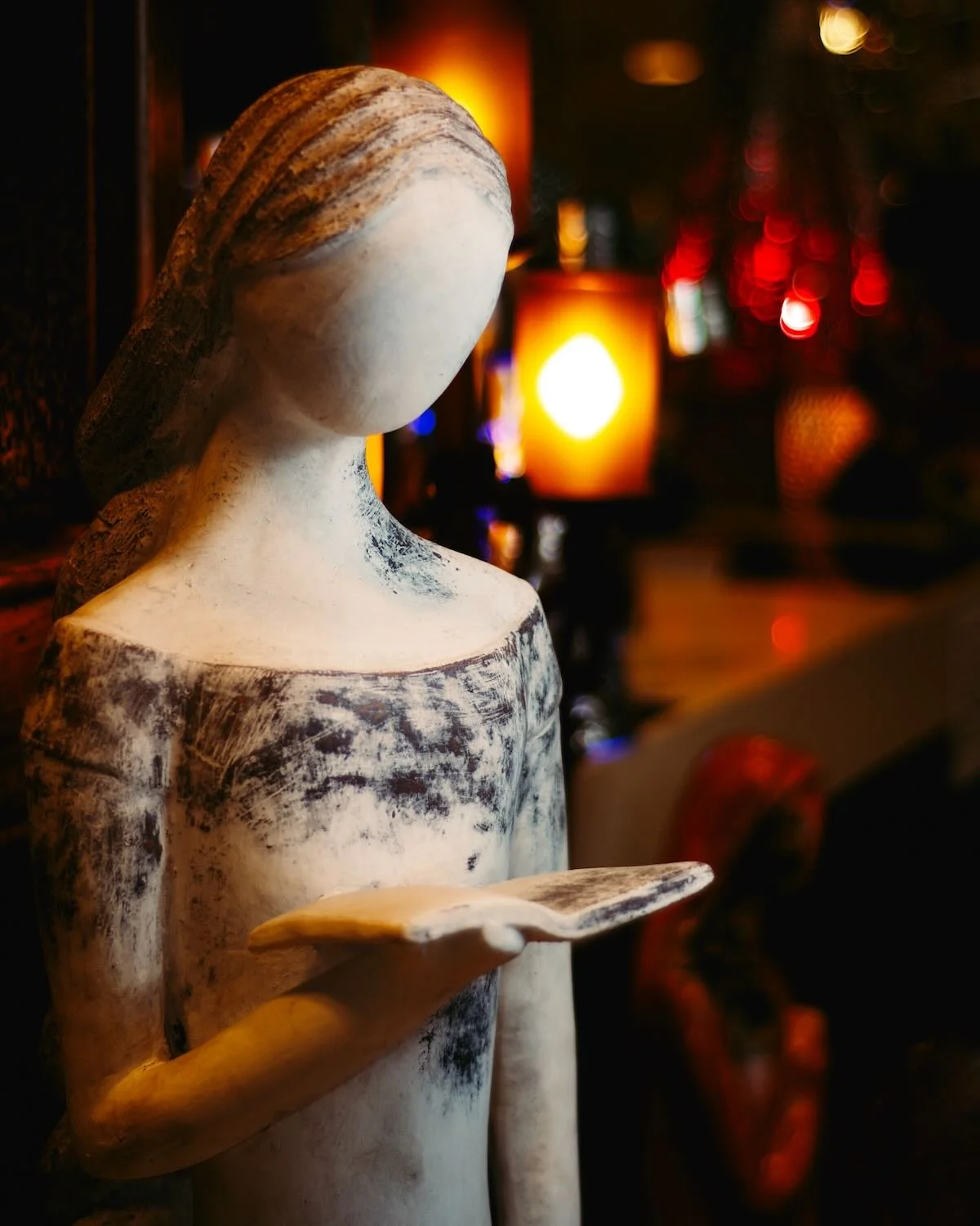 Tall clay lady reading a book from Mexico.