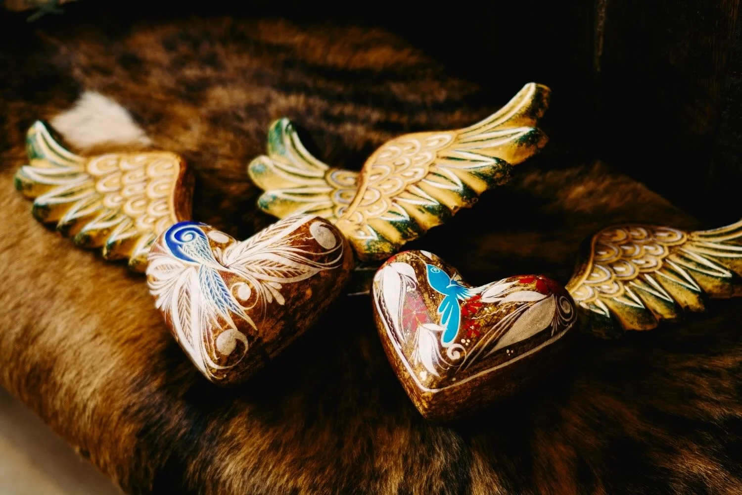 Handmade clay sacred hearts with wings from Mexico.