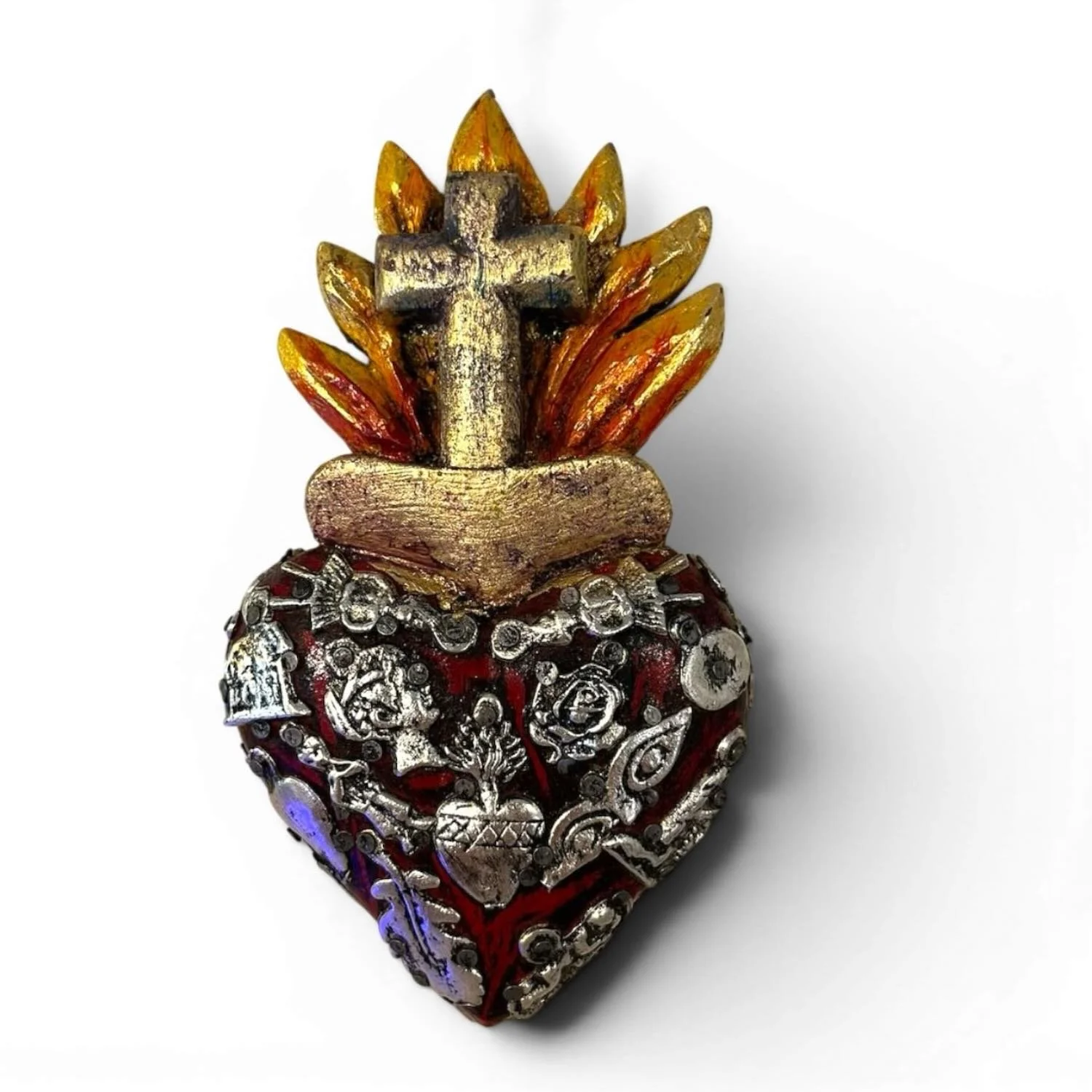 Handmade Mexican Milagros Corazón de Llama sacred heart with a red finish, golden cross, carved flame, and silver milagros charms.
