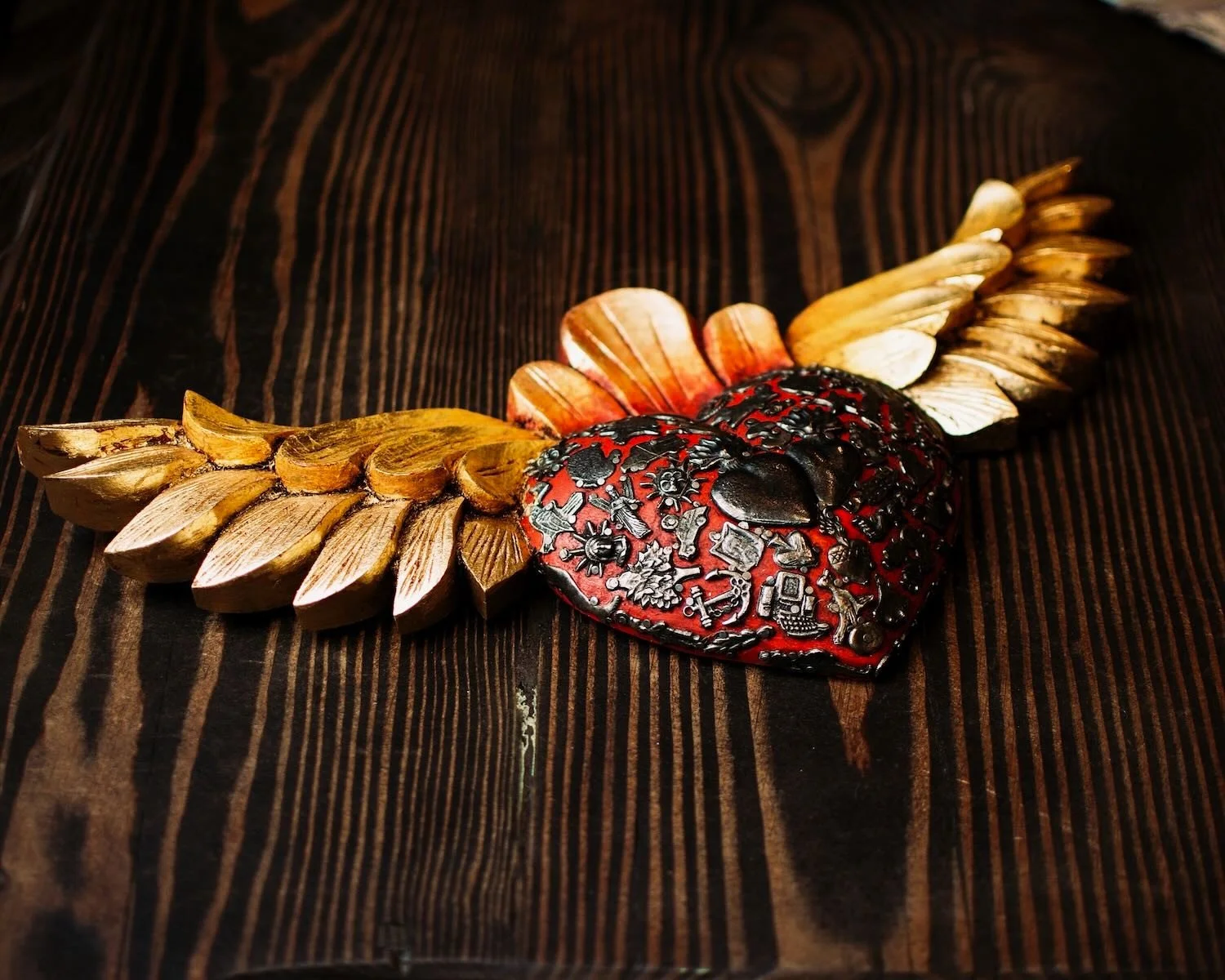 Handmade Mexican golden angel wings wall décor with traditional silver milagros charms.
