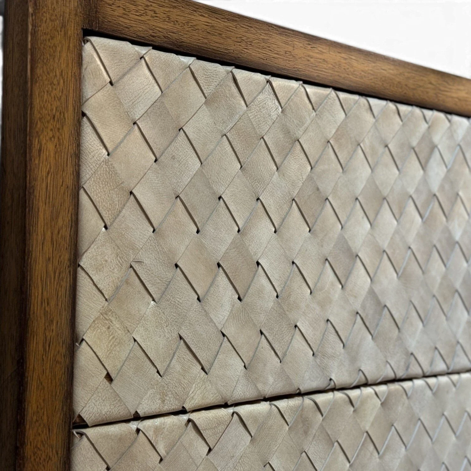 Handmade bed with hand-woven leather headboard framed in solid wood