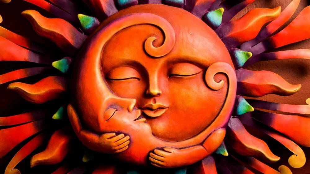 Vibrant wall sun holding the moon while they sleep. Wall art from Mexico.