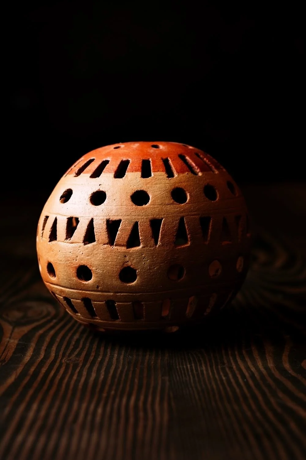 Shop a handmade clay sphere luminaria from Oaxaca, Mexico. Unique cutout design creates warm ambient candlelight for rustic decor.