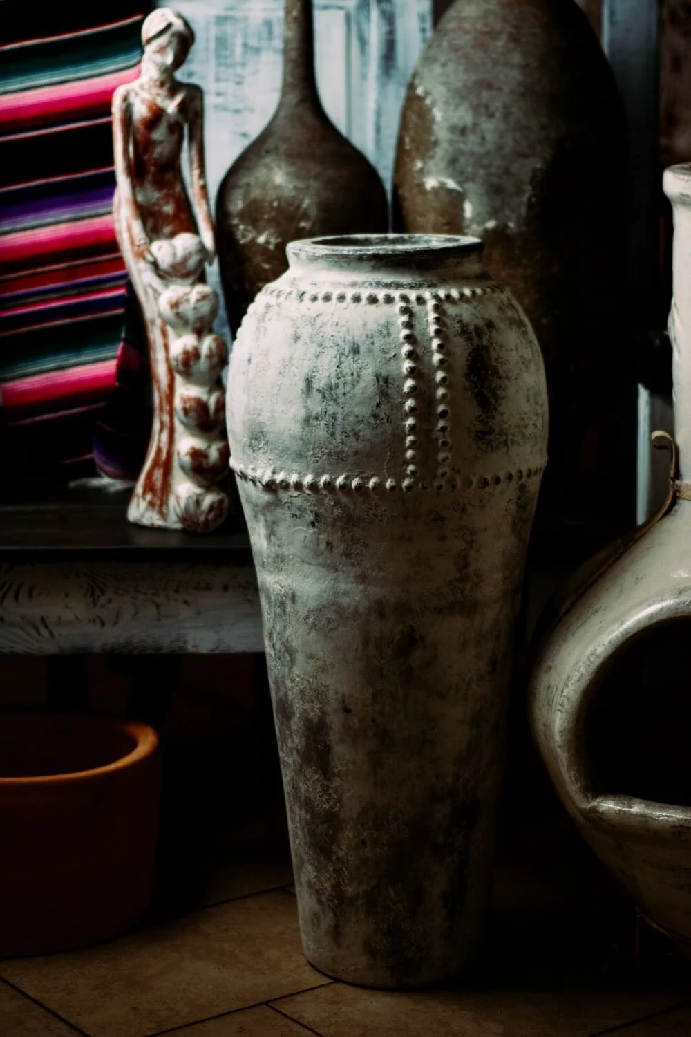 Distressed white clay lady and vase from Mexico.