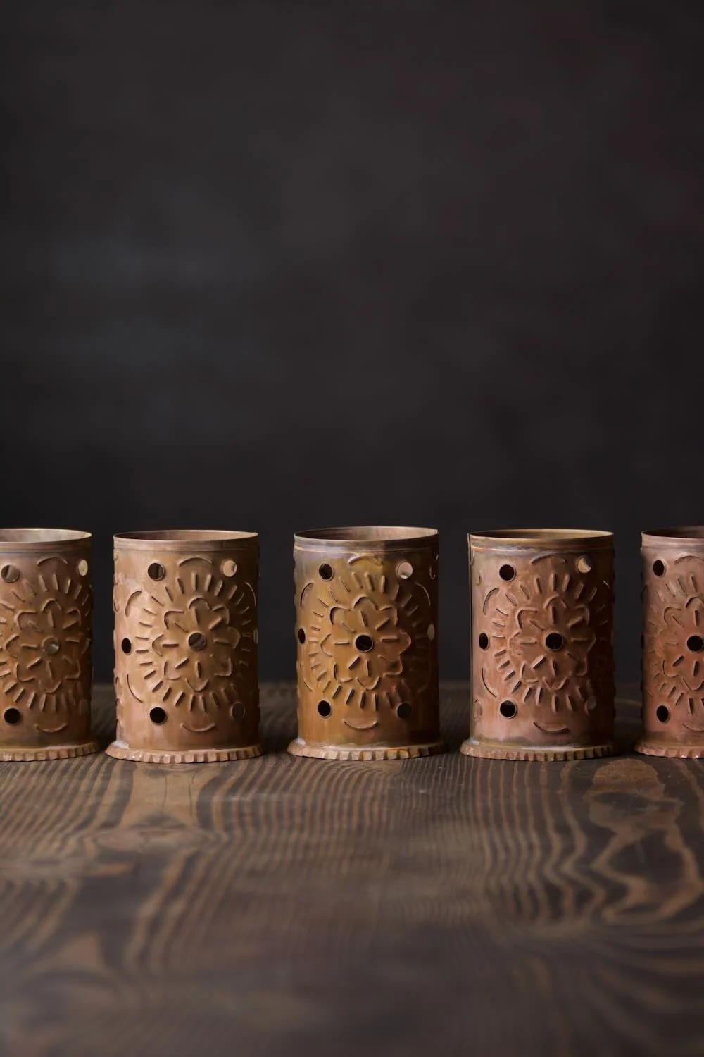 Luminarias de Bronce - Shop handmade bronze luminarias from Mexico. Elegant candle holders with punched designs, perfect for patios, walkways, and ambient lighting.
