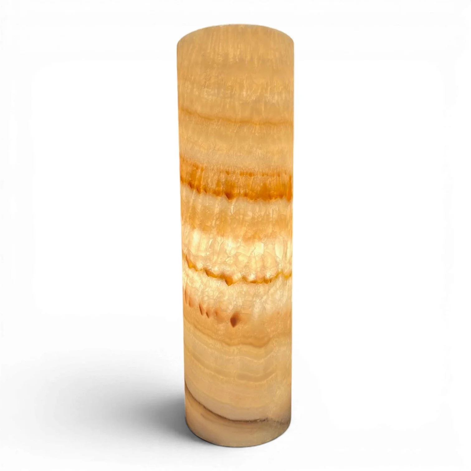 Handmade Mexican cylinder onyx lamp with warm glowing natural stone and coastal luxury design