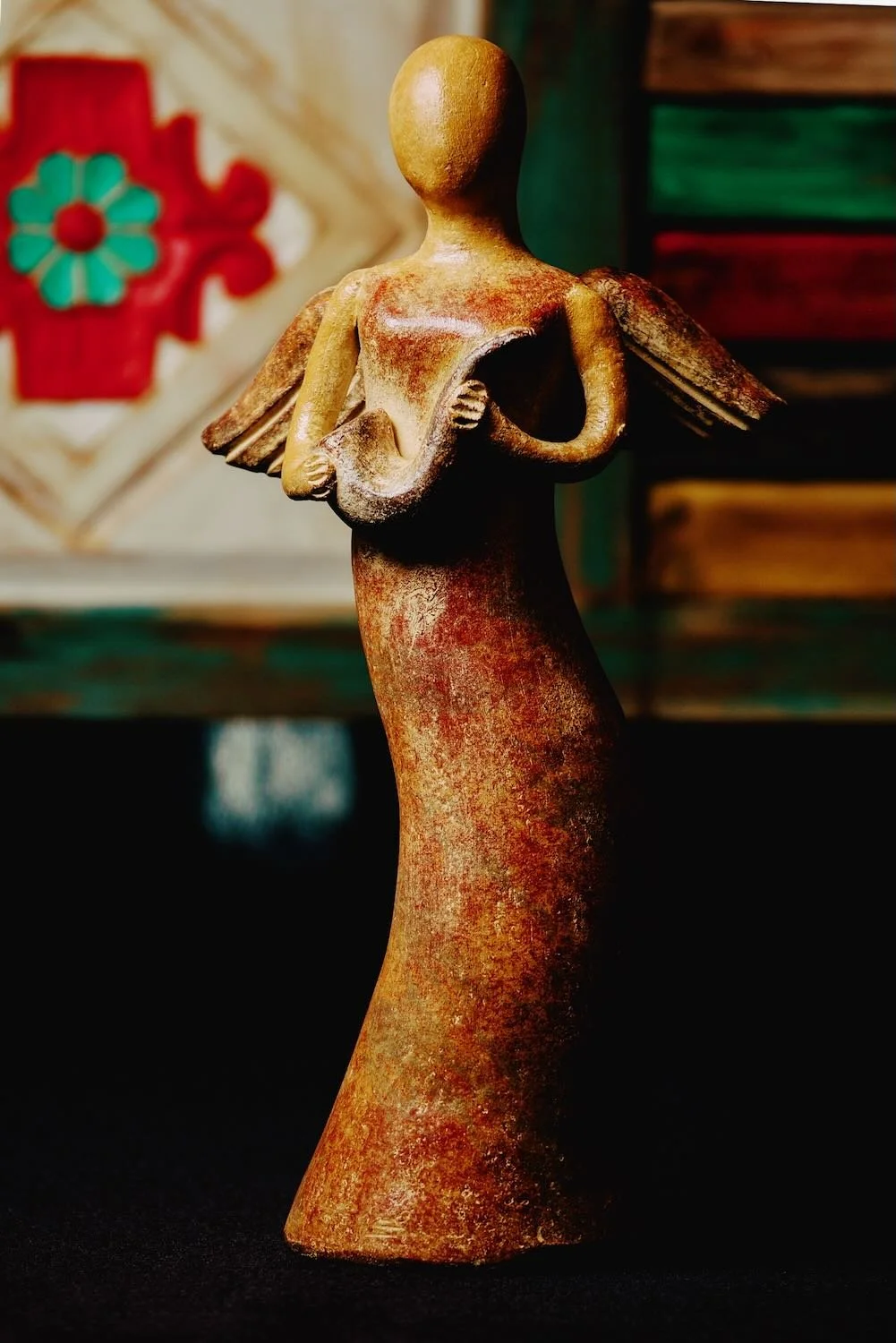 Handmade clay angel with a horn from Mexico.