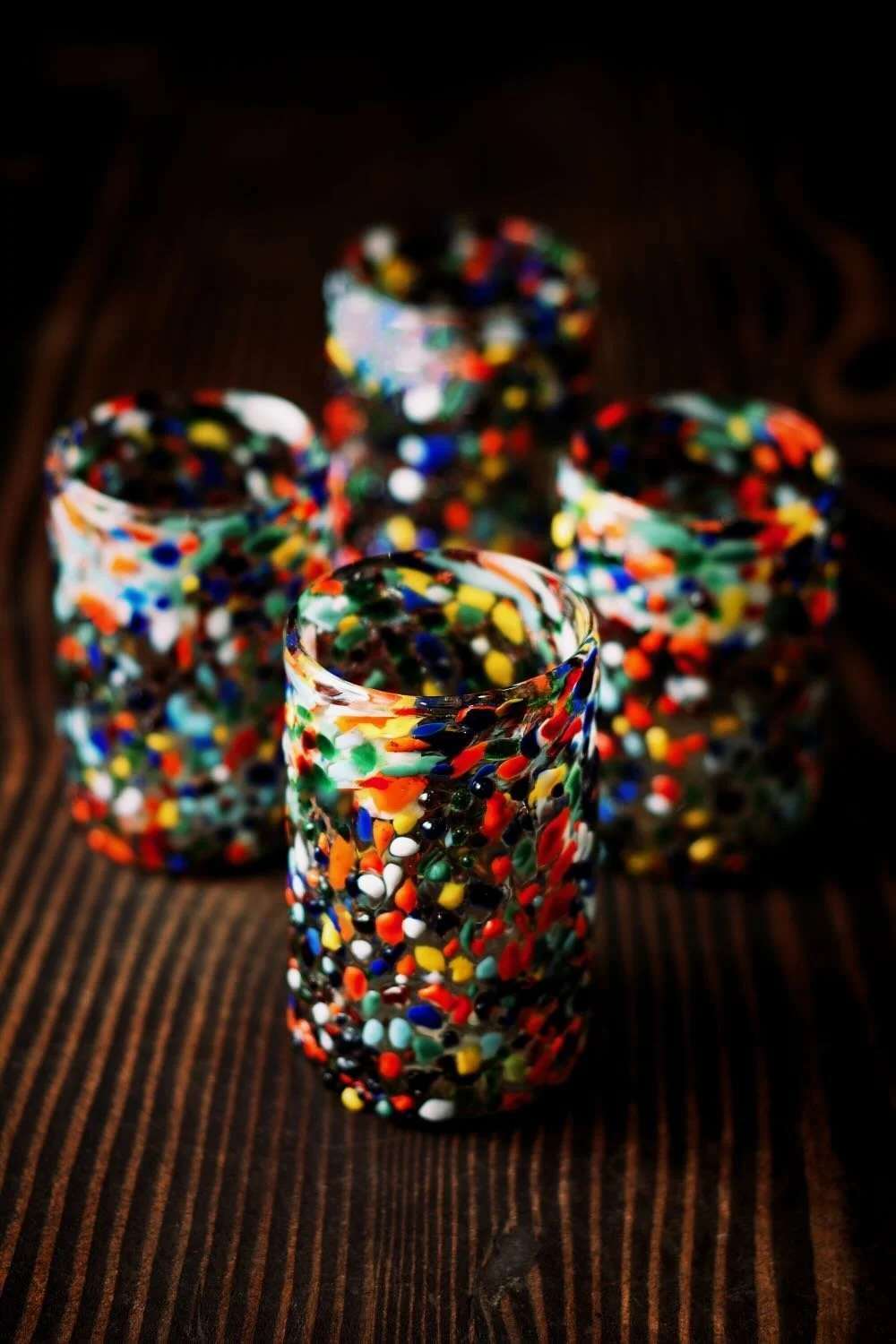 Shop a handblown Guanajuato short glass from Mexico. Colorful confetti design artisan drinkware perfect for everyday use and entertaining.