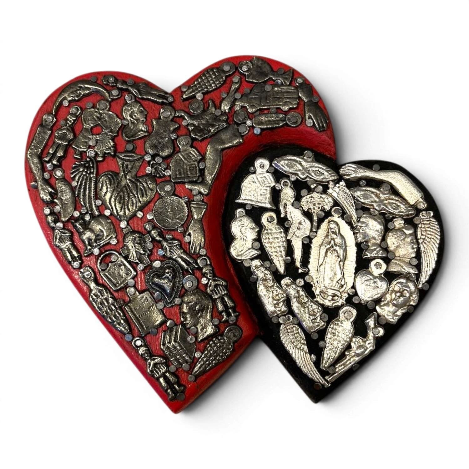 Handmade Mexican double heart wall décor with red and black hand-painted hearts accented by traditional silver Milagros charms.