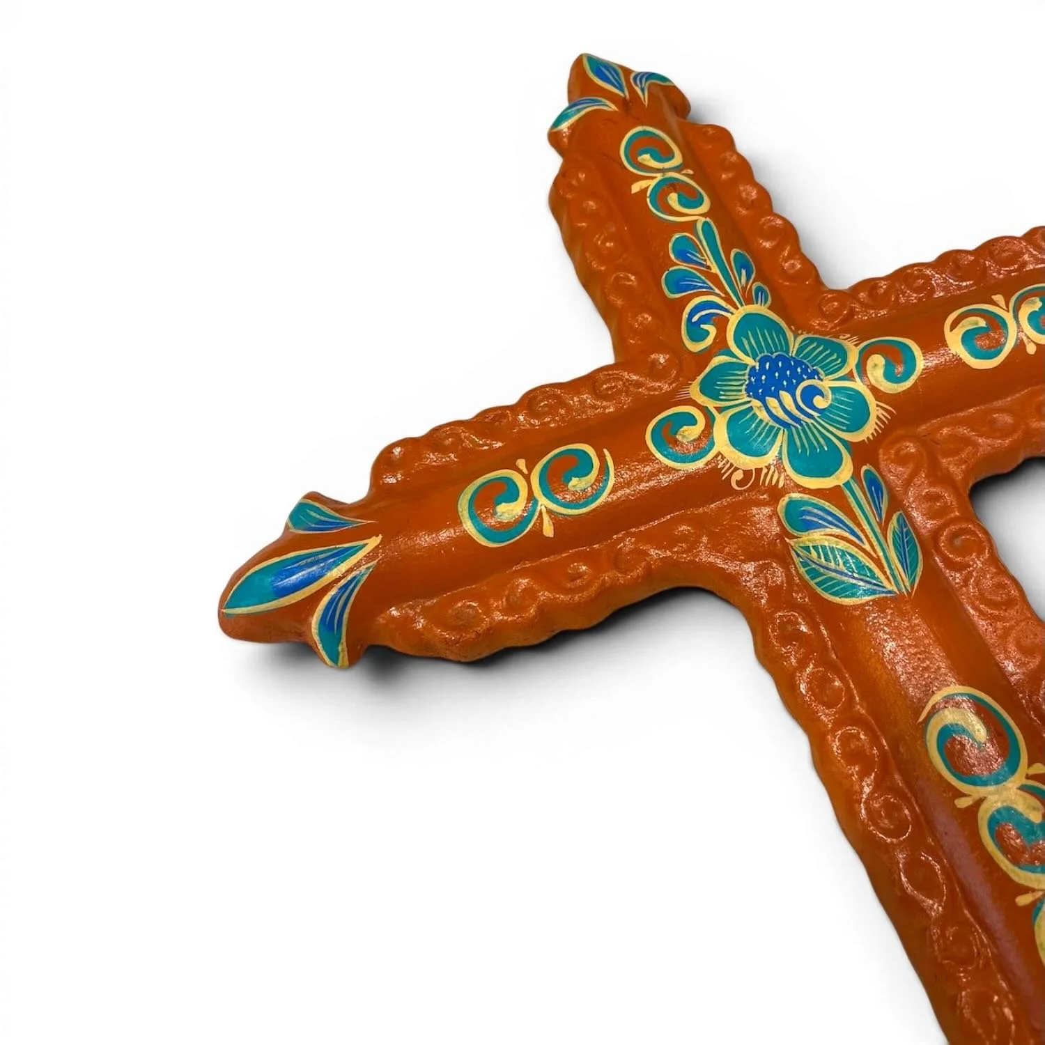 Handmade clay painted cross from Mexico with colorful terracotta and turquoise floral design.