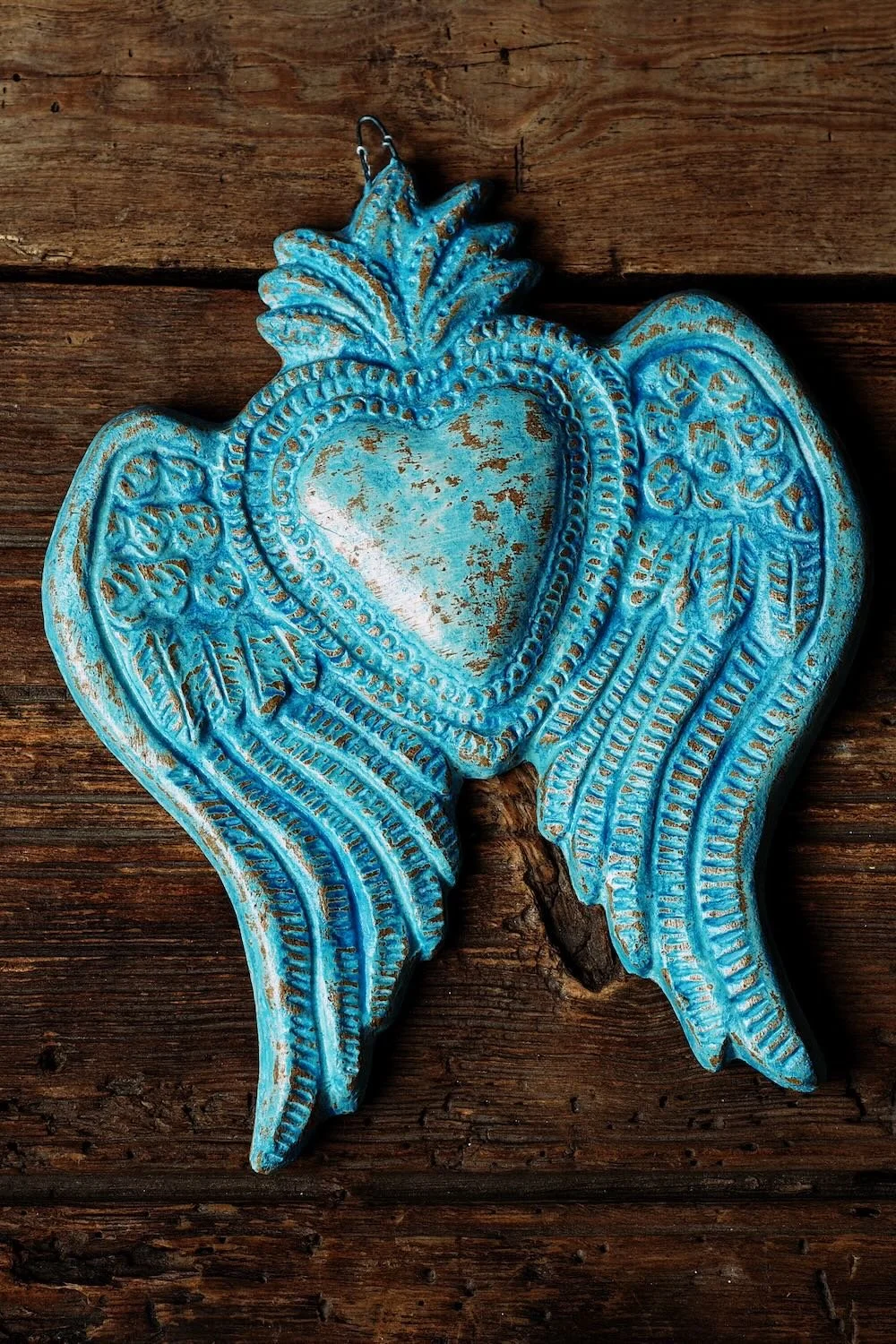 Shop the Blue Clay Heart with Wings handmade in Mexico. Distressed clay heart wall décor with symbolic winged artisan spiritual design.