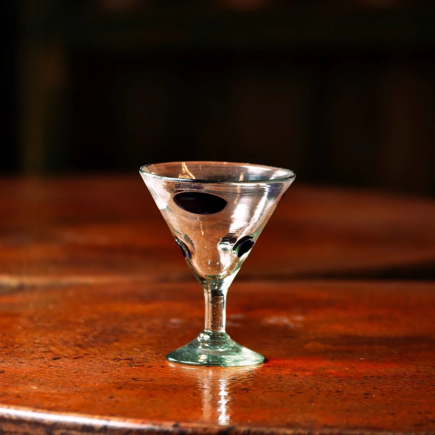 Handmade Mexican Cobalt Blue Polka Dot Martini Glass with artisan swirl and textured glass design.