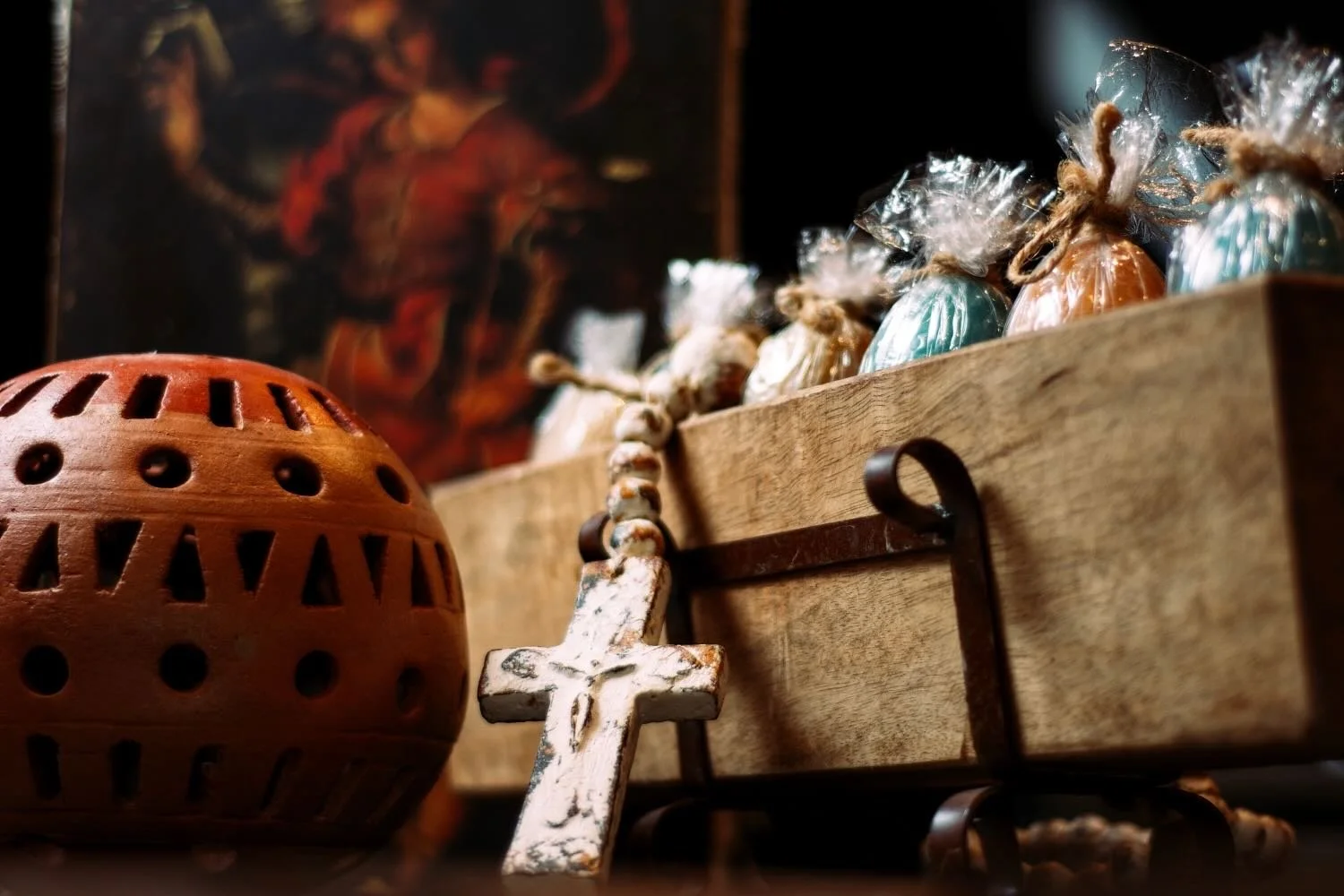 Rustic sugar mold and candles with a clay luminaria from Mexico.