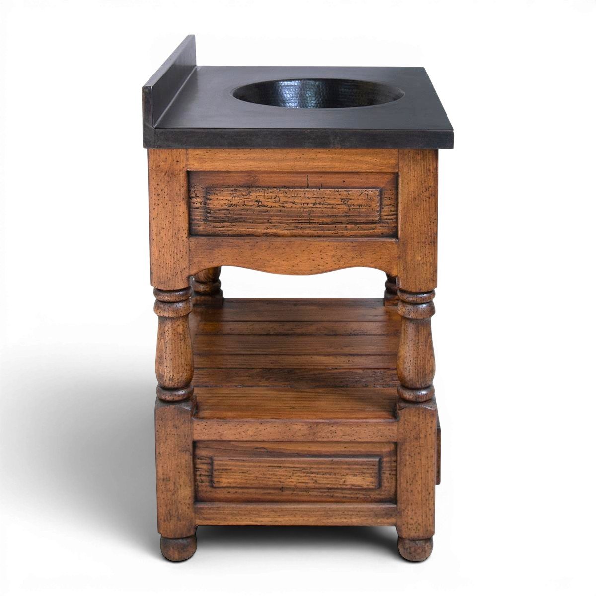 Handmade La Esperanza vanity with black copper sink, carved wood details, iron hardware, drawers, and open shelf storage.