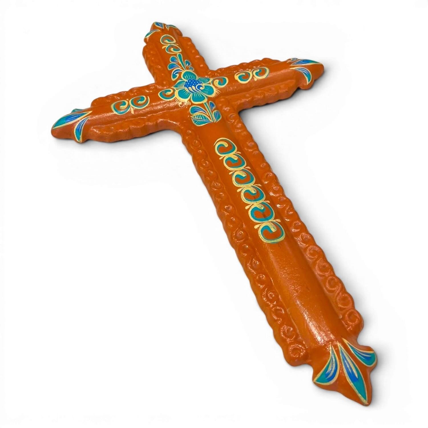 Handmade clay painted cross from Mexico with colorful terracotta and turquoise floral design.