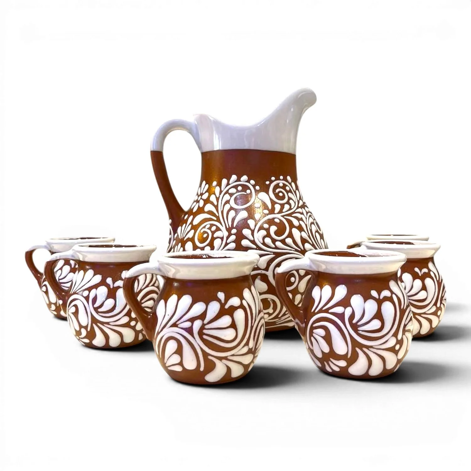 Handcrafted Mexican barro pitcher with white Talavera-inspired design and six matching clay cups.