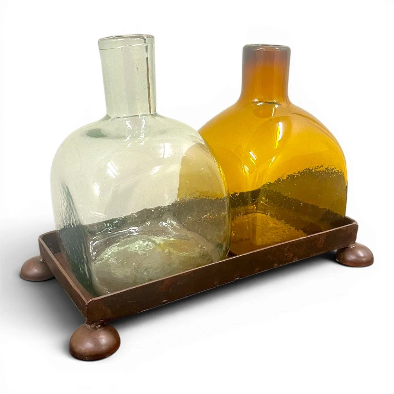 Handmade Mexican serving set featuring two handblown glass bottles and a handcrafted iron tray, perfect for entertaining and rustic décor.