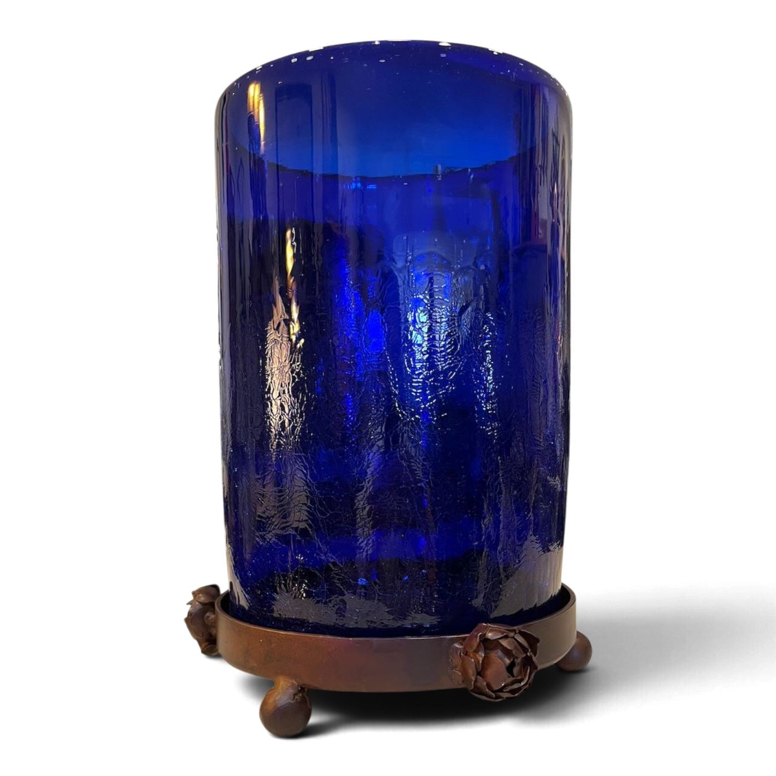 Handmade cobalt blue glass candelabra on a round wrought iron tray with metal roses