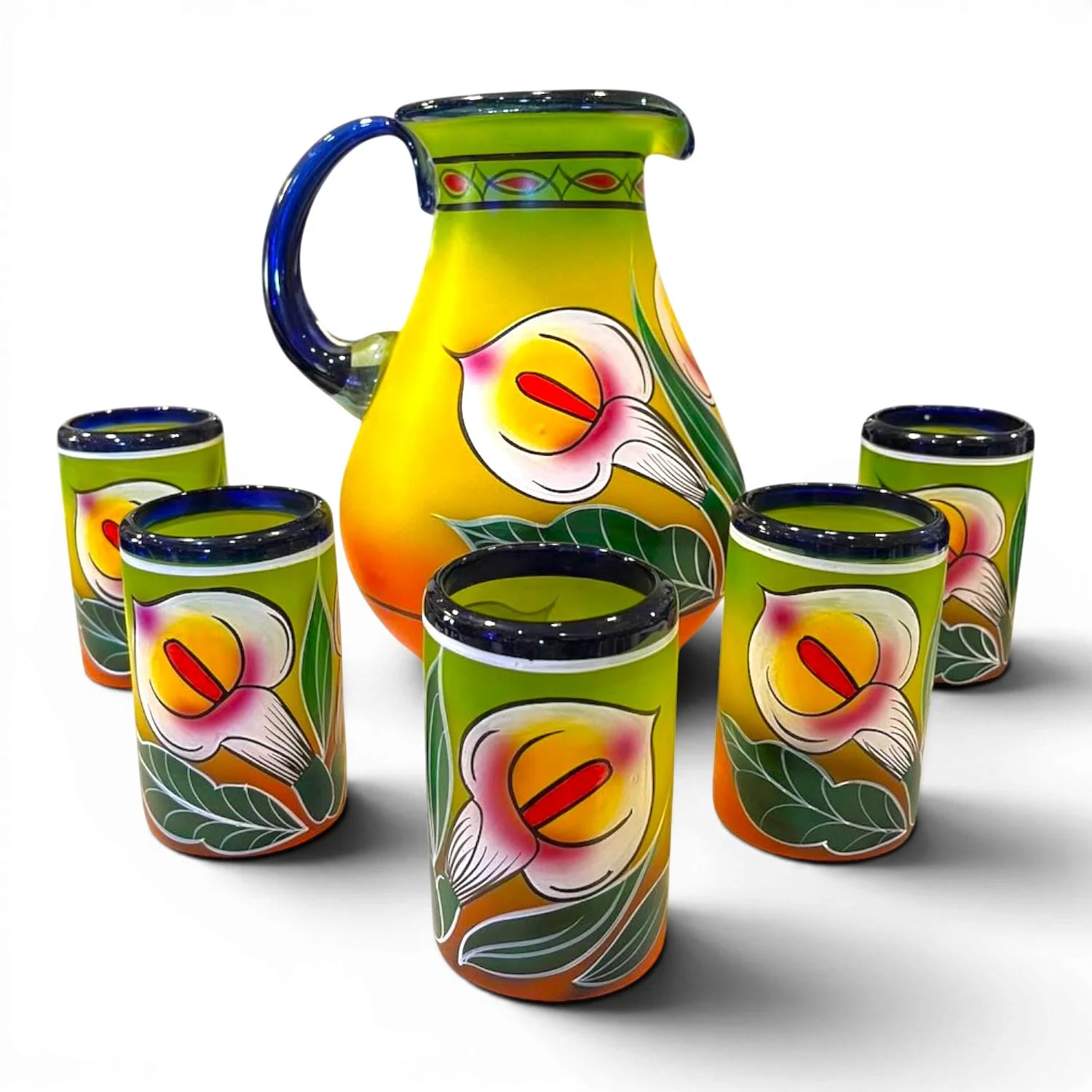 Handblown painted calla lily glass pitcher with five matching tumblers handmade in Mexico featuring blue accents and vibrant floral artwork.