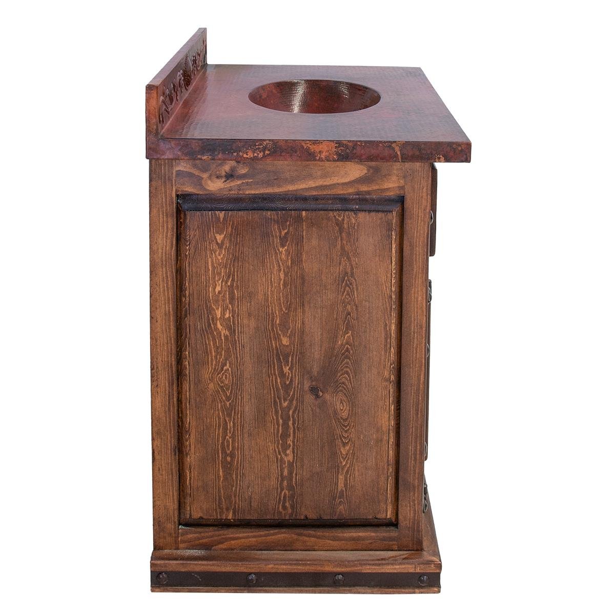 Handmade Coyanosa copper bathroom vanity with embossed copper backsplash, sink, top, door panels, iron hardware, and dark wood finish.