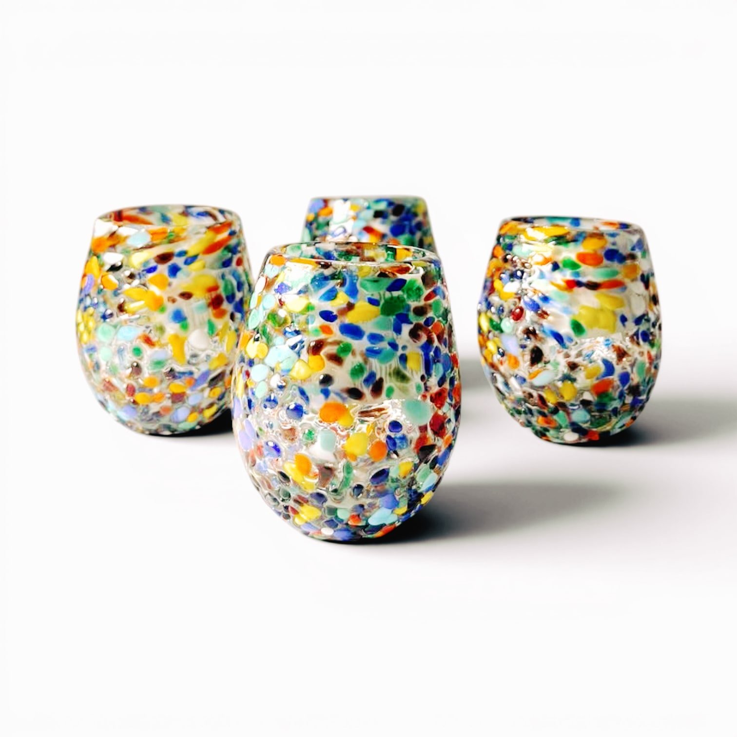 Set of four handmade Mexican Guanajuato confetti shot glasses with colorful textured artisan finish.