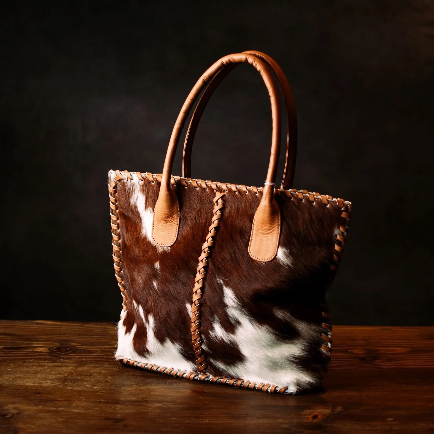 Handmade Brazilian Cheyenne cowhide tote bag with leather handles and detailed stitching
