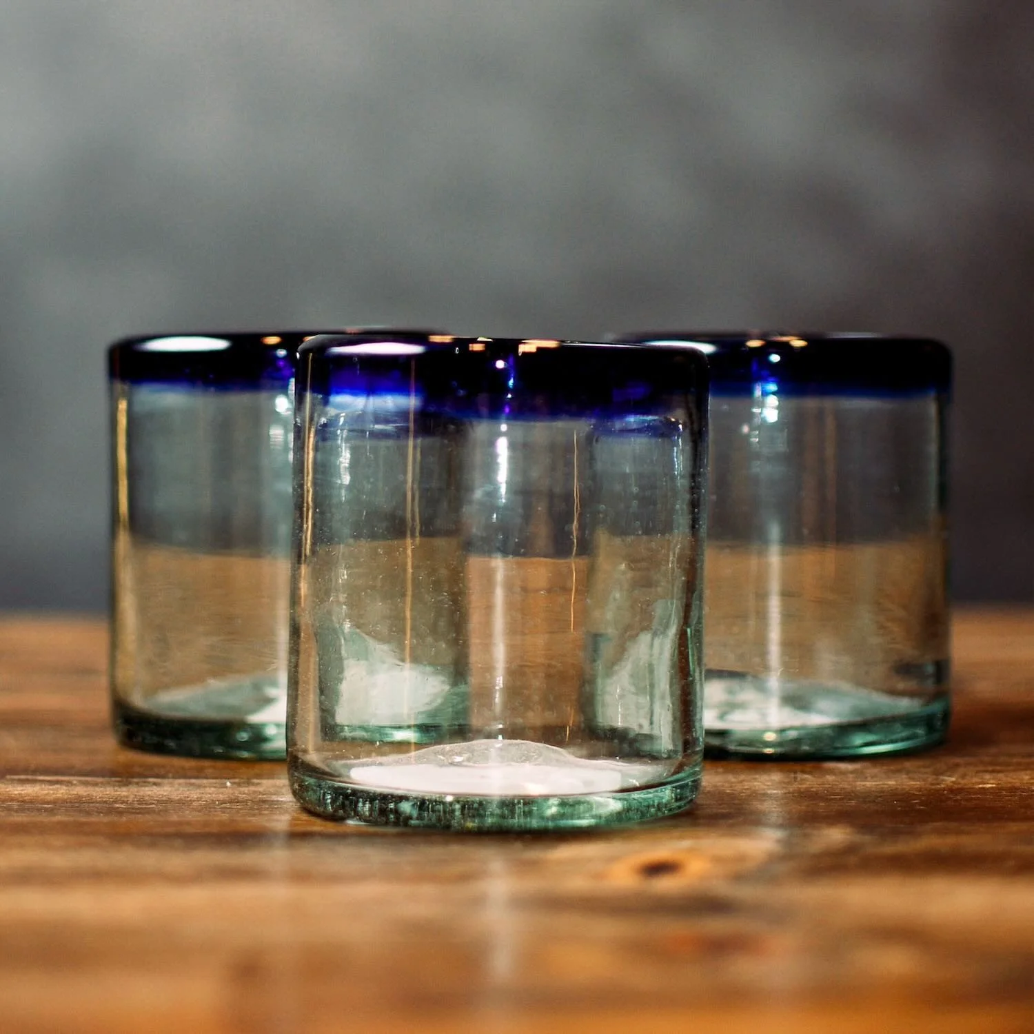 Handmade Mexican Cantina short glass with traditional cobalt blue rim and handblown artisan craftsmanship.