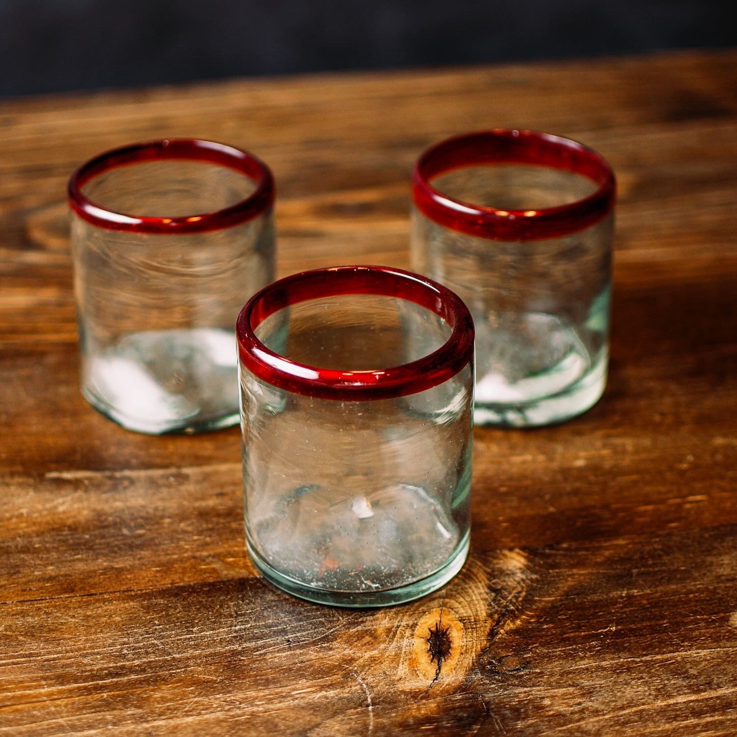 Handmade Mexican Cantina short glass with traditional red rim and handblown artisan craftsmanship.