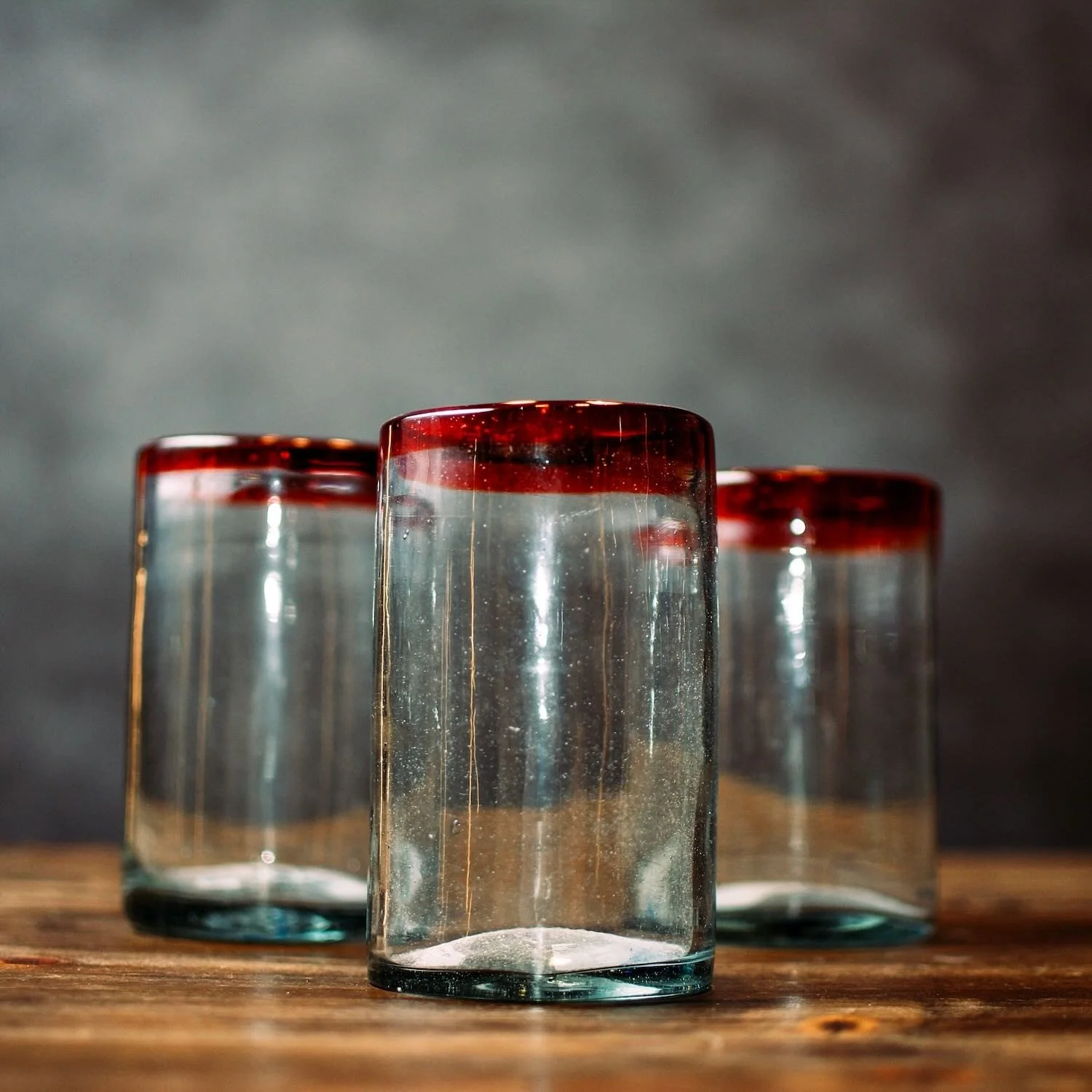 Handmade Mexican Cantina tall glass with traditional red rim and handblown artisan craftsmanship.
