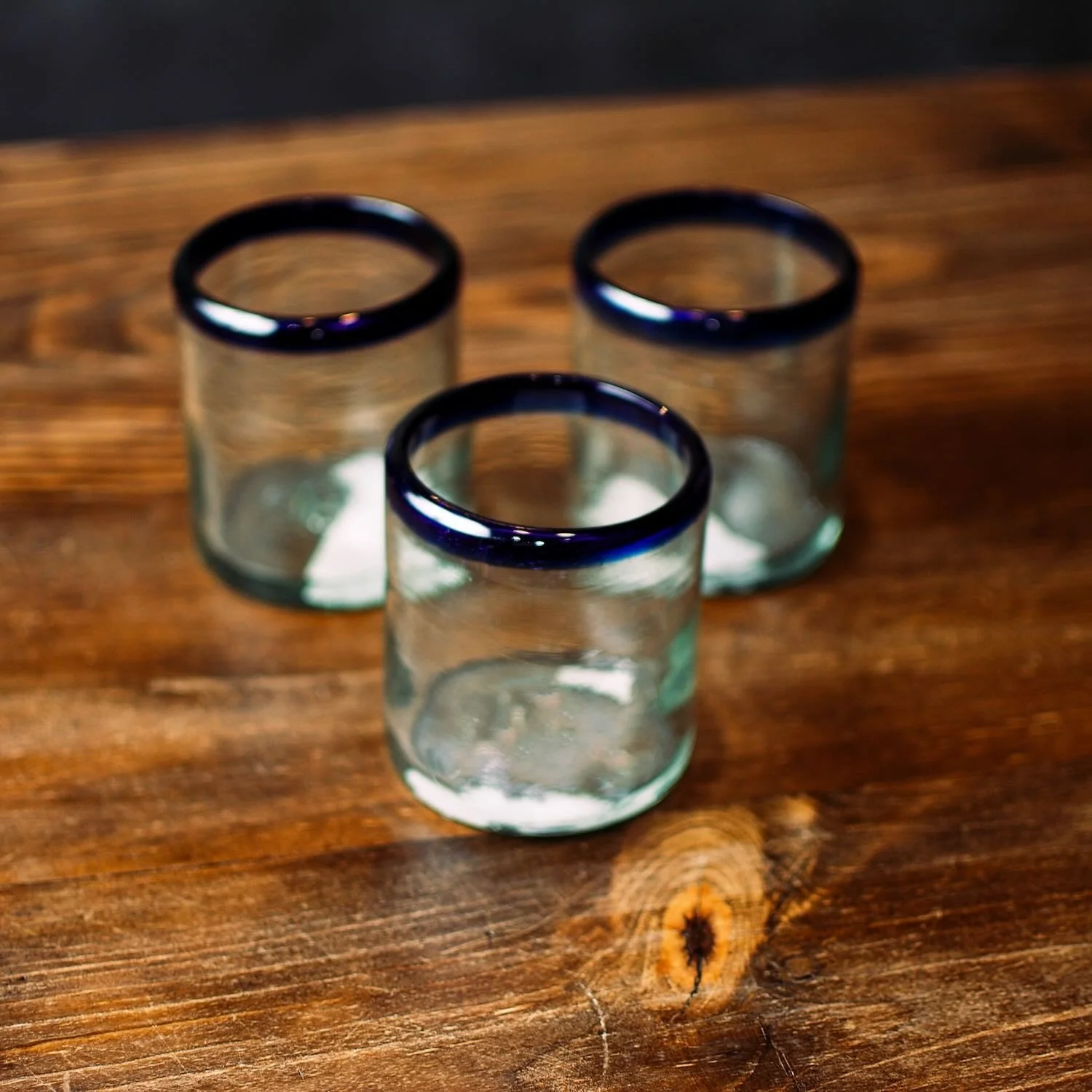 Handmade Mexican Cantina short glass with traditional cobalt blue rim and handblown artisan craftsmanship.