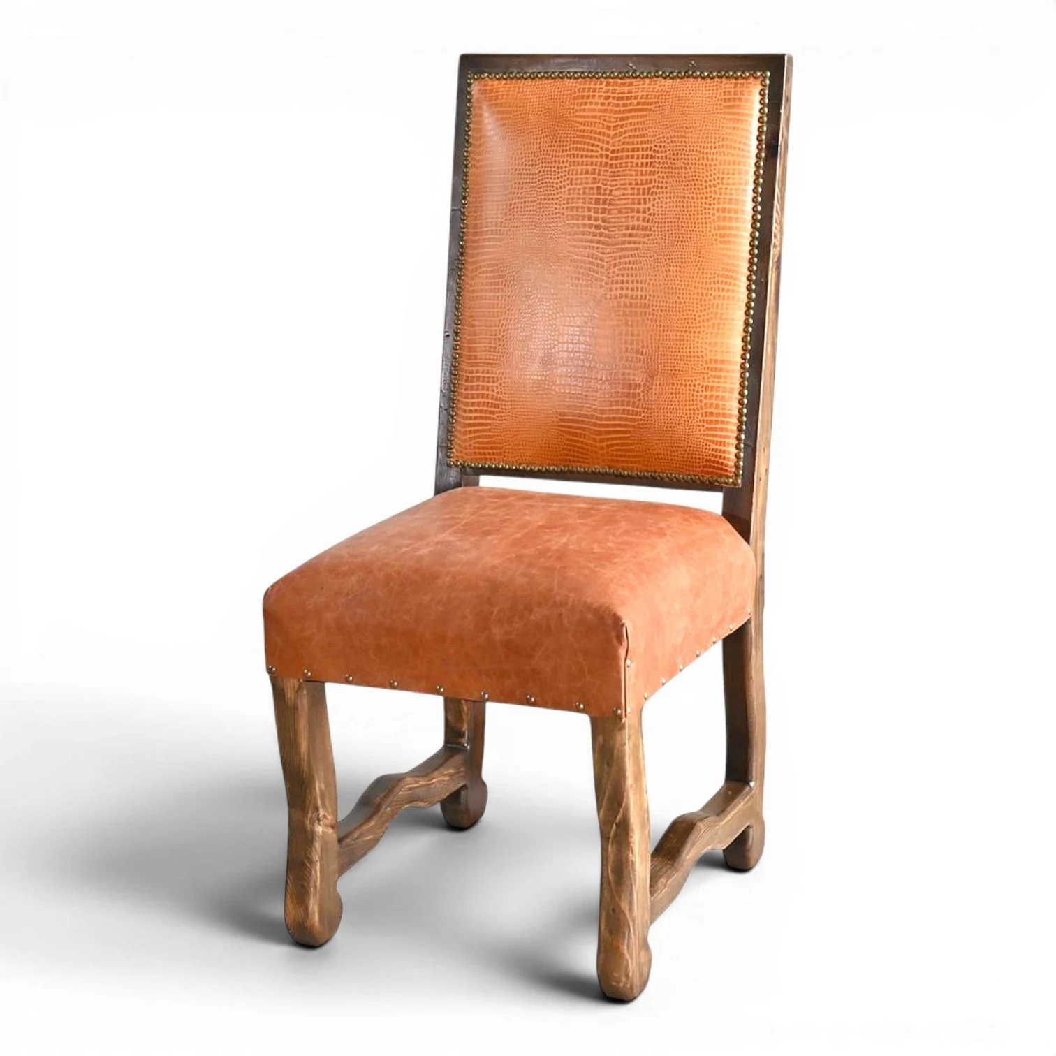 Handmade San Lucas terracotta leather dining chair with embossed leather back, nailhead trim, and dark wood frame crafted in Mexico.