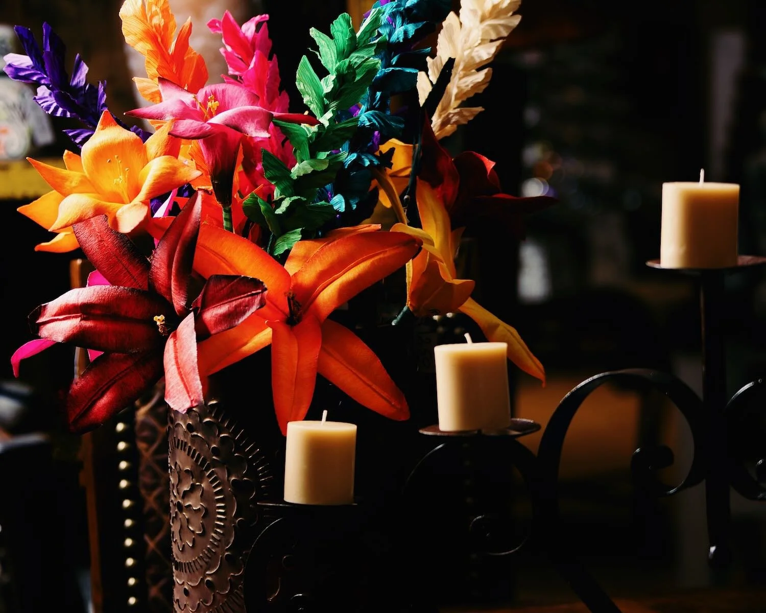 Cornhusk flowers, iron candelabra and punched tin luminaria from Mexico - Milagros Rústicos