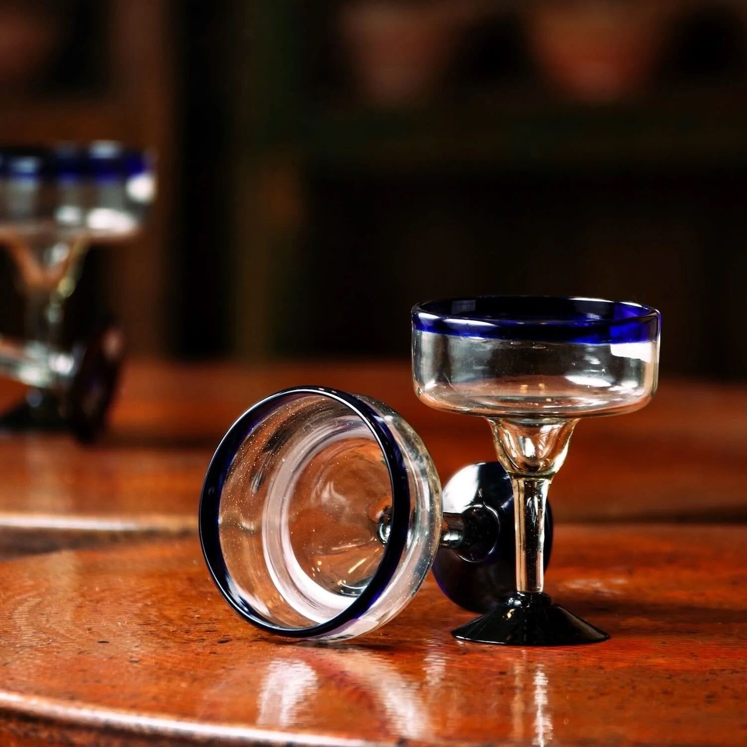 Set of two handmade Mexican handblown margarita glasses with traditional cobalt blue rims.