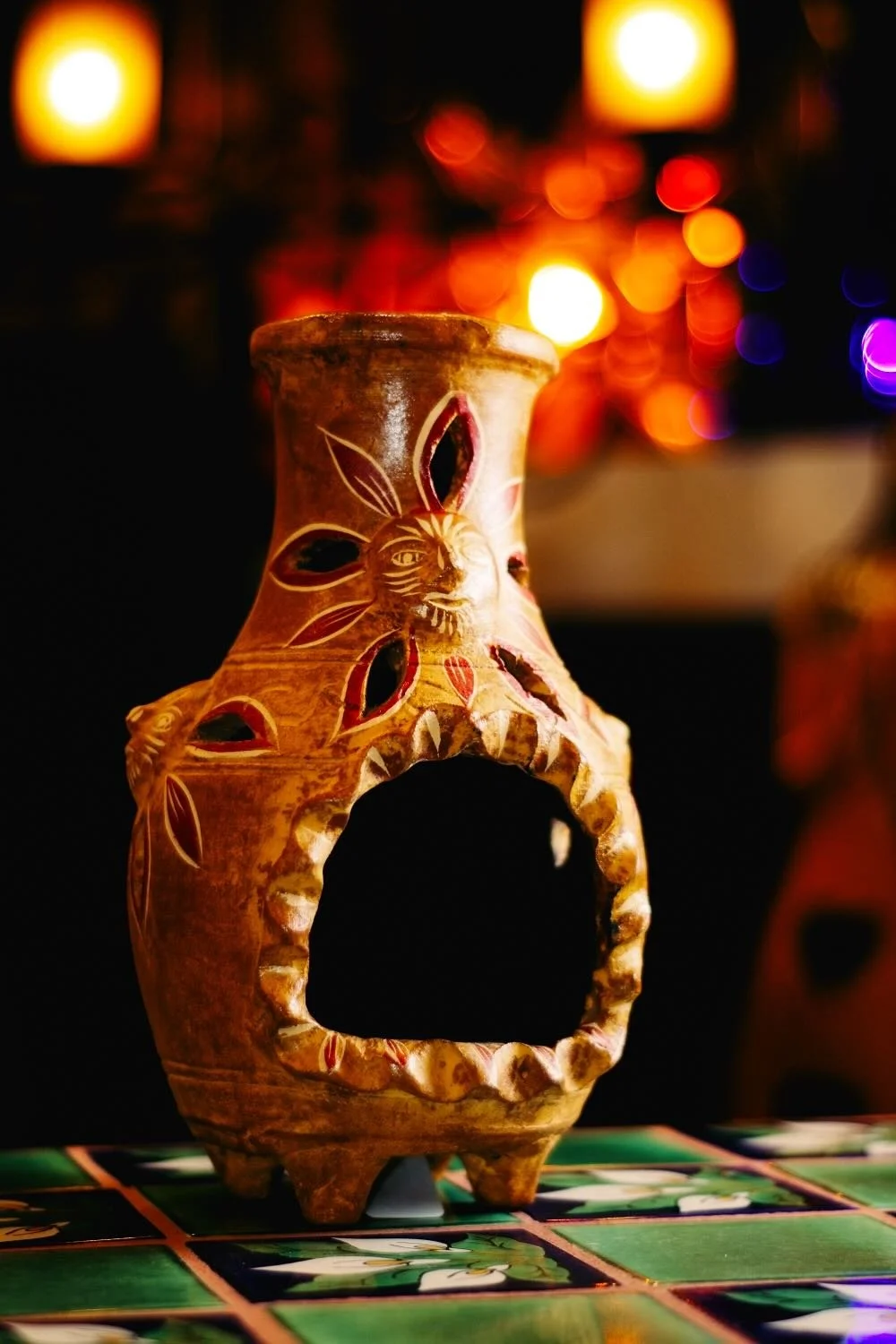 Terracotta mini chiminea with sun motif from Mexico.